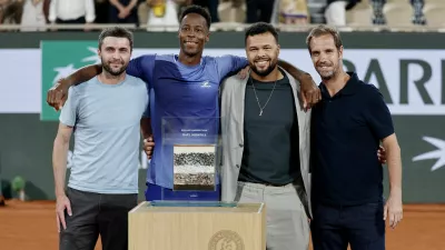 Tennis - French Open - Roland Garros, Paris, France - May 25, 2026 France's Gael Monfils poses with former tennis players Gilles Simon, Jo-Wilfried Tsonga and Richard Gasquet after receiving an award from Roland Garros after losing his first round match against France's Hugo Gaston REUTERS/Benoit Tessier