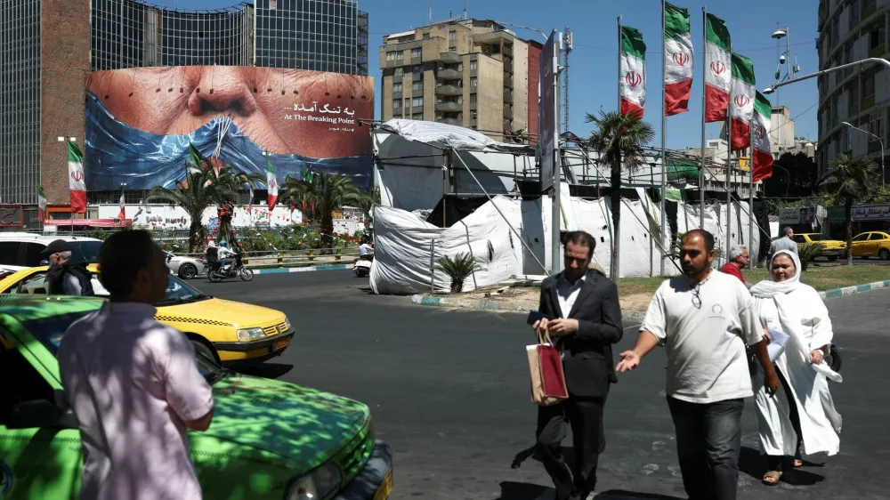 People walk past an anti-U.S. billboard depicting U.S. President Donald Trump and the Strait of Hormuz, in Tehran, Iran, May 26, 2026. Majid Asgaripour/WANA (West Asia News Agency) via REUTERS ATTENTION EDITORS - THIS PICTURE WAS PROVIDED BY A THIRD PARTY