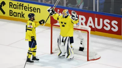 Ice Hockey - IIHF World Championships - Group B - Sweden v Slovakia - BCF Arena, Fribourg, Switzerland - May 26, 2026 Sweden's Magnus Hellberg and Mattias Ekholm celebrate after the match REUTERS/David W Cerny