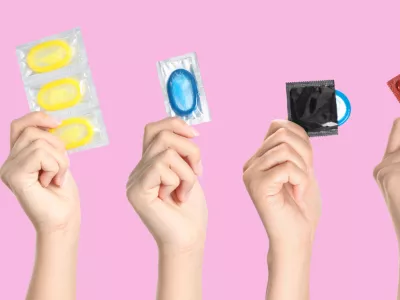 Collage with photos of women holding condoms on pink background, closeup. Banner design / Foto: Liudmila Chernetska