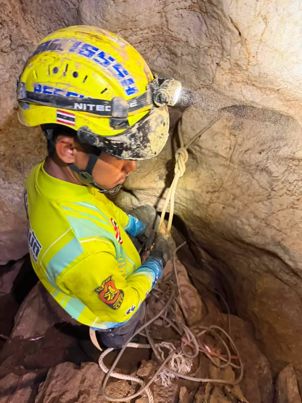 In this image released by Metta Tham Rescue Kalasin, a rescuer prepares to reach people who have been trapped in a cave in Xaisomboun province, Laos, Tuesday, May 26, 2026. (Metta Tham Rescue Kalasin via AP)