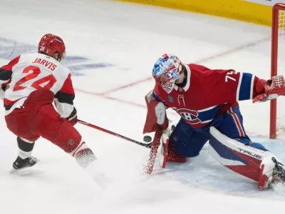 Montreal Canadiens goaltender Jakub Dobes (75) makes a save against Carolina Hurricanes' Seth Jarvis (24) during third period of Game 4 of the NHL Eastern Conference final Stanley Cup playoff series game in Montreal on Wednesday, May 27, 2026. (Christinne Muschi/The Canadian Press via AP)