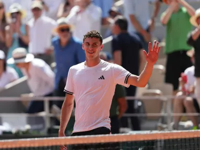 Juan Manuel Cerundolo of Argentina celebrates winning against Jannik Sinner of Italy after their second round men's singles tennis match at the French Open tennis tournament in Paris, Thursday, May 28, 2026. (AP Photo/Thibault Camus)