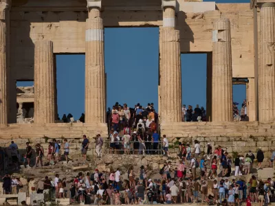 Tourists visit the 5th century BC Propylaea on the Acropolis Hill during a hot day, in Athens, Greece, Thursday, May 28, 2026.(AP Photo/Petros Giannakouris)