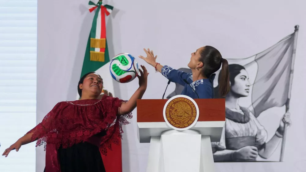 Yolett Cervantes Cuaquehua plays with a ball alongside Mexican President Claudia Sheinbaum after receiving a ticket from her for the opening match of the 2026 World Cup, the June 11 Mexico&ndash;South Africa game at Ciudad de Mexico Stadium, during Sheinbaum's morning press conference at the National Palace in Mexico City, Mexico, May 29, 2026. REUTERS/Quetzalli Nicte-Ha   TPX IMAGES OF THE DAY