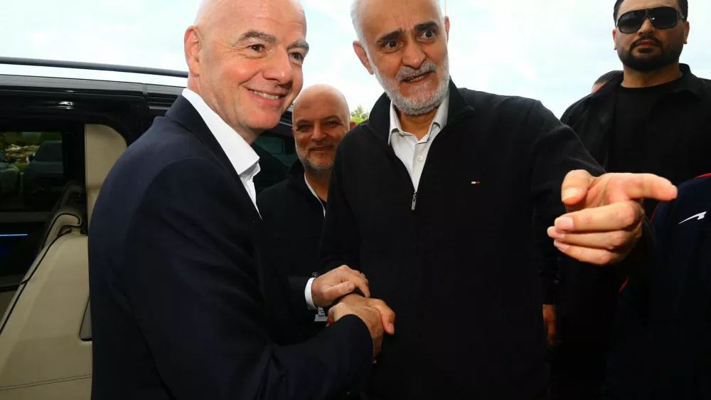 Soccer Football - International Friendly - Costa Rica v Iran - Antalya Stadium, Antalya, Turkey - March 31, 2026 First vice president of the Islamic Republic of Iran Football Federation Mehdi Mohammad Nabi shakes hands with FIFA president Gianni Infantino before the match REUTERS/Kaan Soyturk