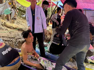 This image provided by the Association Of Volunteers For Lao People, shows rescuers after they safely evacuated the villagers, who had been trapped in a cave in Xaisomboun province, Laos, Saturday, May 30, 2026. (Association Of Volunteers For Lao People via AP)