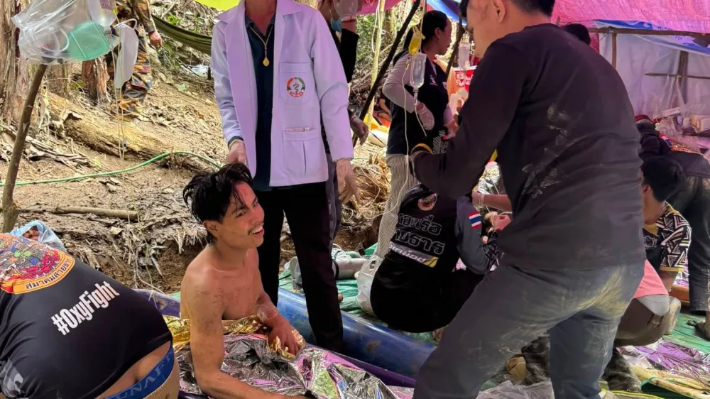 This image provided by the Association Of Volunteers For Lao People, shows rescuers after they safely evacuated the villagers, who had been trapped in a cave in Xaisomboun province, Laos, Saturday, May 30, 2026. (Association Of Volunteers For Lao People via AP)