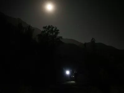 A blue moon rises behind mountain in San Jose de Maipo outskirts of capital Santiago, Chile, Saturday, May 30, 2026. (AP Photo/Esteban Felix)