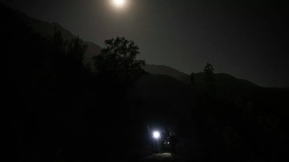 A blue moon rises behind mountain in San Jose de Maipo outskirts of capital Santiago, Chile, Saturday, May 30, 2026. (AP Photo/Esteban Felix)