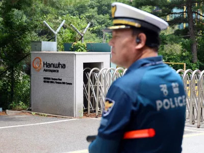 A police officer controls the area in front of the main gate of Hanwha Aerospace's factory that caught fire after an explosion, in Daejeon, South Korea, June 1, 2026.  Yonhap via REUTERS  THIS IMAGE HAS BEEN SUPPLIED BY A THIRD PARTY. NO RESALES. NO ARCHIVES. SOUTH KOREA OUT. NO COMMERCIAL OR EDITORIAL SALES IN SOUTH KOREA.