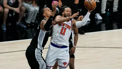New York Knicks guard Jalen Brunson (11) drives past San Antonio Spurs forward Victor Wembanyama, left, during the first half of Game 1 of the NBA Finals basketball series, Wednesday, June 3, 2026, in San Antonio. (AP Photo/David J. Phillip)
