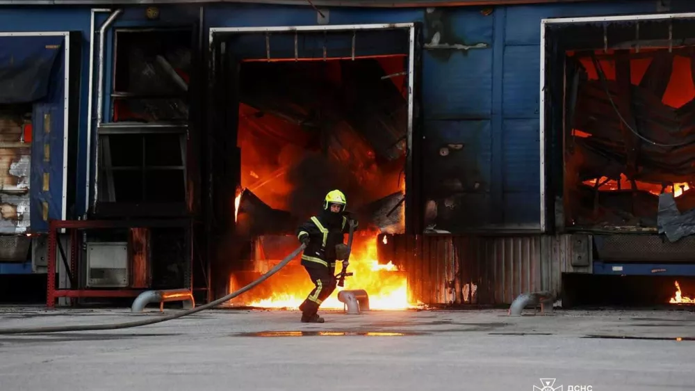 In this photo provided by the Ukrainian Emergency Services on Thursday, June 4, 2026, a rescue worker puts out a fire of a storage depot damaged after a Russian strike on Dnipropetrovsk region, Ukraine. (Ukrainian Emergency Service via AP)