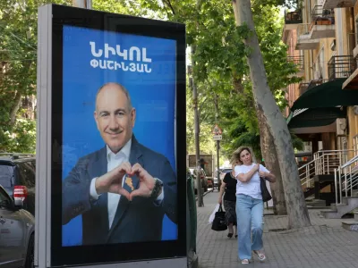 People walk past campaign banners with portraits of Prime Minister Nikol Pashinyan of the Civil Contract party, ahead of the June 7 parliamentary election, in Yerevan, Armenia June 3, 2026. Hayk Baghdasaryan/Photolure via REUTERS ATTENTION EDITORS - THIS IMAGE HAS BEEN SUPPLIED BY A THIRD PARTY.