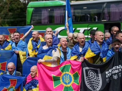 Ukrainian soldiers pose for a photo after returning from captivity after a POWs exchange between Russia and Ukraine, in Chernyhiv region, Ukraine, Friday, June 5, 2026. (AP Photo/Evgeniy Maloletka)