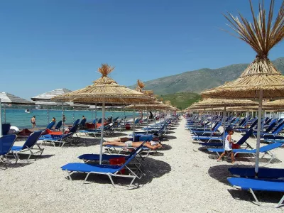 A view of a beach in the Orikum near the city of Vlore, some 180 km (113 miles) south of Albania's capital Tirana, June 10, 2009. By closing Albania to the outside world, its Communist leaders preserved vast swaths of virgin Mediterranean coastline from unbridled development. Yet trash and sewage from the consumer and construction explosion after communism endanger the pristine beauty that could fuel future economic growth through tourism. Picture taken June 10, 2009. To match feature ALBANIA-TRASH/    REUTERS/Stringer (ALBANIA ENVIRONMENT TRAVEL)
