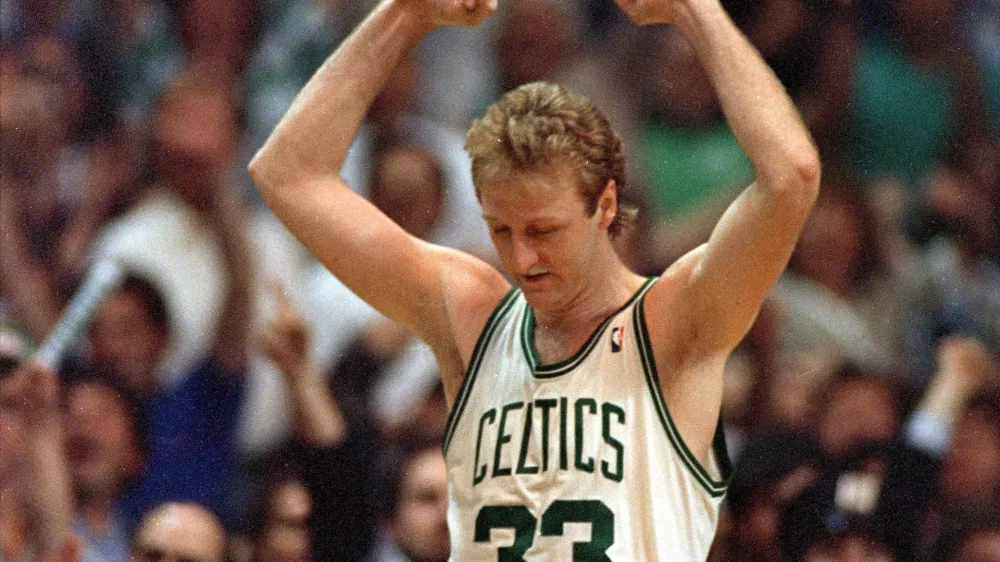 Larry Bird of the Boston Celtics raises his arms in victory at the end of Boston's 108-107 win over the Detroit Pistons in the fifth game of their NBA playoff series at the Boston Garden, Ma., Tuesday night, May 26, 1987. (AP Photo/Peter Southwick)