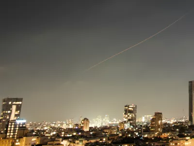 A projectile streaks through the sky over central Israel during an Iranian missile attack, Sunday, June 7, 2026. (AP Photo/Ohad Zwigenberg)