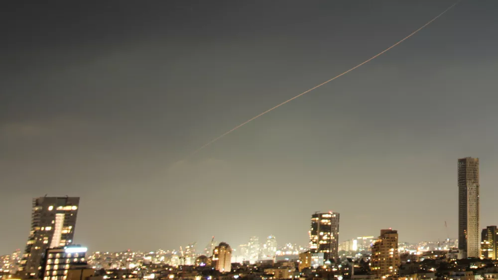 A projectile streaks through the sky over central Israel during an Iranian missile attack, Sunday, June 7, 2026. (AP Photo/Ohad Zwigenberg)