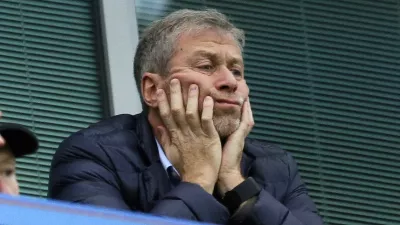 FILE - Chelsea soccer club owner Roman Abramovich sits in his box before their English Premier League soccer match against Sunderland at Stamford Bridge stadium in London, Dec. 19, 2015. Chelsea owner Roman Abramovich has on Saturday, Feb. 26, 2022 suddenly handed over the â€śstewardship and careâ€ť of the Premier League club to its charitable foundation trustees. The move came after a member of the British parliament called for the Russian billionaire to hand over the club in the wake of Russiaâ€™s invasion of Ukraine. (AP Photo/Matt Dunham, File)