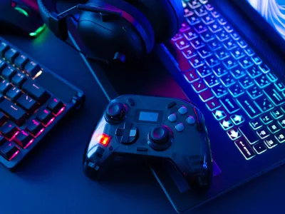 gamer work space concept, top view a gaming gear, mouse, keyboard, joystick on black table background.
