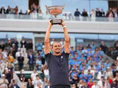 Alexander Zverev of Germany lifts the trophy after winning the men's final match against Flavio Cobolli of Italy at the French Open tennis tournament in Paris, Sunday, June 7, 2026. (AP Photo/Christophe Ena)