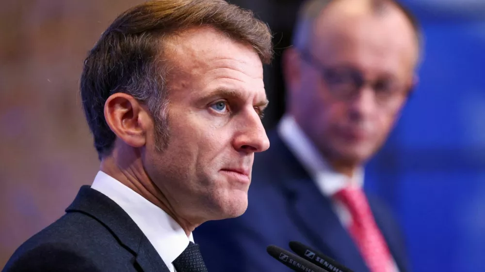 FILE PHOTO: French President Emmanuel Macron, flanked by German Chancellor Friedrich Merz, speaks during a joint press conference on the day of a Summit on European Digital Sovereignty, a high-level Franco-German meeting focused on discussing Europe's digital future, security, and independence, in Berlin, Germany, November 18, 2025. REUTERS/Christian Mang/File Photo