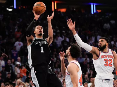 San Antonio Spurs forward Victor Wembanyama (1) shoots over New York Knicks center Karl-Anthony Towns (32) during second half of Game 3 of the NBA Finals basketball series, Monday, June 8, 2026, in New York. (AP Photo/Ross D. Franklin)