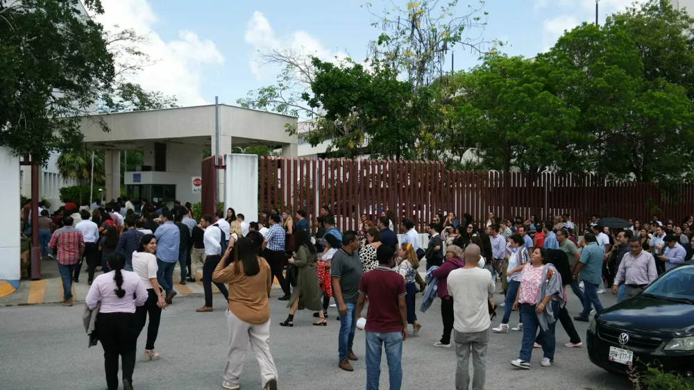 Employees return to the Federal Judiciary building following an evacuation after a 6.1-magnitude earthquake struck off the coast of Cuba and was felt in the resort cities of Cancun, Playa del Carmen and Tulum, in Cancun, Mexico, June 8, 2026. REUTERS/Paola Chiomante