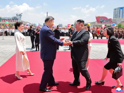 In this photo provided by the North Korean government, Chinese President Xi Jinping, center left, shakes hands with North Korean leader Kim Jong Un, center right, during a welcome ceremony in Pyongyang, Monday, June 8, 2026. Independent journalists were not given access to cover the event depicted in this image distributed by the North Korean government. The content of this image is as provided and cannot be independently verified. Korean language watermark on image as provided by source reads: "KCNA" which is the abbreviation for Korean Central News Agency. (Korean Central News Agency/Korea News Service via AP)