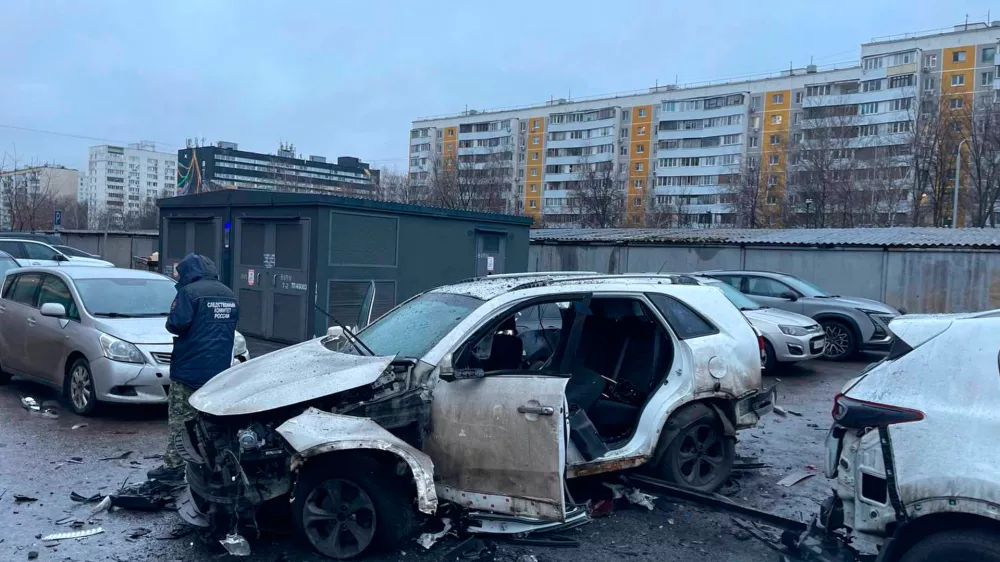 This photo provided by Investigative Committee of Moscow on Monday, Dec. 22, 2025, shows an investigator working at the scene where Lt. Gen. Fanil Sarvarov, head of the Operational Training Directorate of the Russian Armed Forces General Staff, was killed by an explosive device placed under his car in Moscow. (Investigative Committee of Moscow via AP)