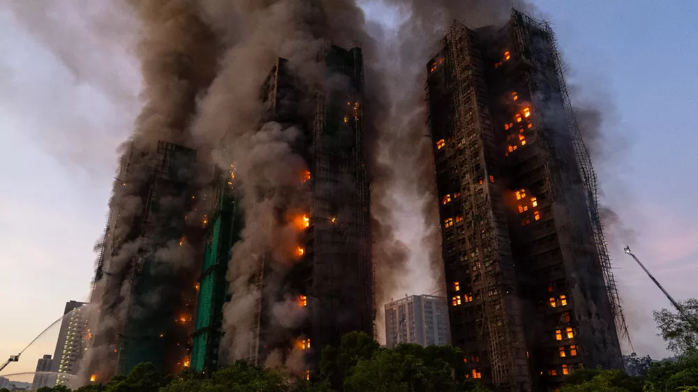 FILE - Smoke rises after a fire broke out at Wang Fuk Court, a residential estate in the Tai Po district of Hong Kong's New Territories, Nov. 26 2025. (AP Photo/Chan Long Hei, File)