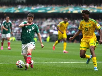 Mexico's Armando Gonzalez (14) controls the ball watches South Africa's Ime Okon (21) defends in the second half during the World Cup Group A soccer match between Mexico and South Africa in Mexico City, Thursday, June 11, 2026. (AP Photo/Eduardo Verdugo)