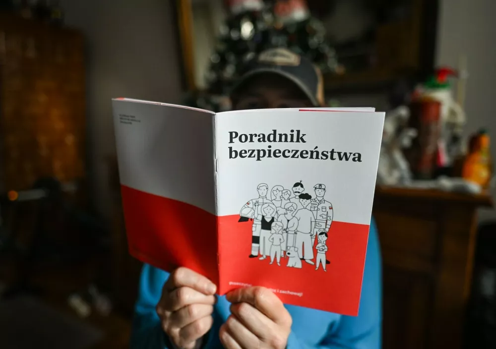 KRAKOW, POLAND - JANUARY 18:A person reads a copy of the Security Guide (Polish: Poradnik Bezpieczenstwa), distributed to households nationwide by the Polish government, in Krakow, Poland, on January 18, 2026.The guide aims to help residents prepare for crisis situations such as natural disasters, infrastructure failures, cyber threats and potential military scenarios, with 16.8 million copies scheduled for delivery by the end of January.Security Guide Delivered To Households Across Poland, Krakow - 18 Jan 2026,Image: 1067214354, License: Rights-managed, Restrictions:, Model Release: no