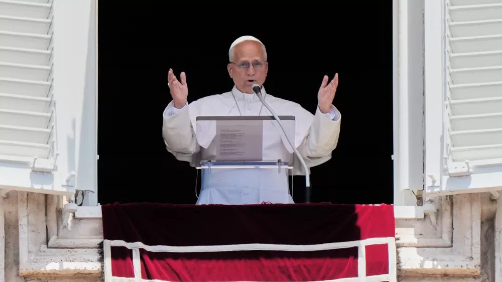 Pope Leo XIV delivers his blessing as he recites the Angelus noon prayer from the window of his studio overlooking St.Peter's Square, at the Vatican, Sunday, June 14, 2026. (AP Photo/Andrew Medichini)