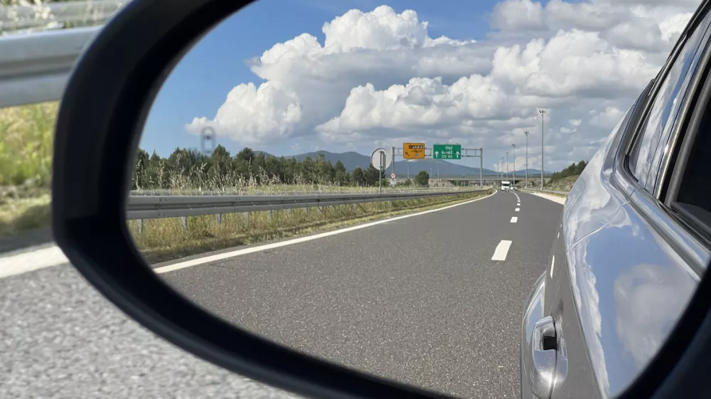 View of a modern highway in the rearview mirror of a passenger car (Zadar, Croatia) - Pogled na modernu autocestu u retrovizoru osobnog automobila (Zadar, Hrvatska)