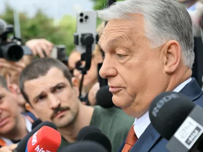 Fidesz party head and former prime minister Viktor Orban, center, speaks to the press as he arrives at the opposition Fidesz party's working congress meeting, in Budapest, Hungary, Saturday, June 13, 2026. (Zoltan Mathe/MTI via AP)