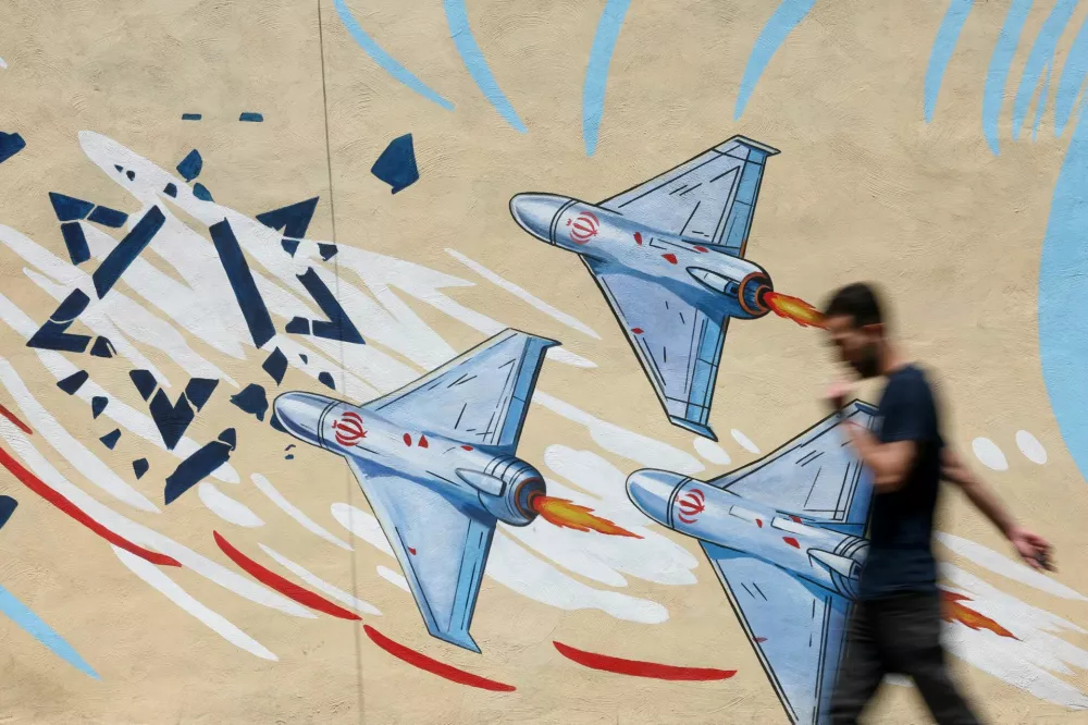 An Iranian man walks next to an anti-Israeli mural on a street in Tehran, Iran June 6, 2026. Majid Asgaripour/WANA (West Asia News Agency) via REUTERS  ATTENTION EDITORS - THIS PICTURE WAS PROVIDED BY A THIRD PARTY. ISRAEL OUT. NO COMMERCIAL OR EDITORIAL SALES IN ISRAEL. NO ACCESS FOR ISRAELI MEDIA. NO USE BBC PERSIAN. NO USE VOA PERSIAN. NO USE MANOTO. NO USE IRAN INTERNATIONAL. NO USE RADIO FARDA. DIGITAL: NO USE BBC PERSIAN. NO USE VOA PERSIAN. NO USE MANOTO. NO USE IRAN INTERNATIONAL. NO USE RADIO FARDA.