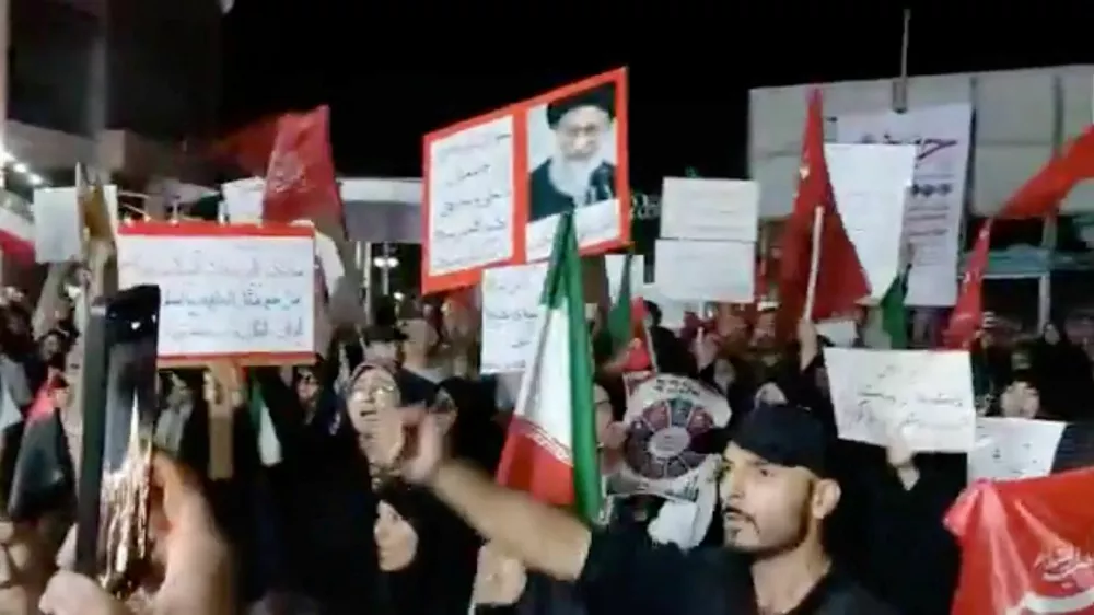 People take part in a protest ahead of an expected signing of an agreement to end the U.S.-Iran conflict, according to U.S. and Pakistani leaders, in Tehran, Iran, in this still image obtained from a social media video released on June 13, 2026. Social Media/via REUTERS THIS IMAGE HAS BEEN SUPPLIED BY A THIRD PARTY. NO RESALES. NO ARCHIVES. BEST QUALITY AVAILABLE. VERIFICATION: Building and columns matched file and satellite imagery. Coordinates of the square: 35.698960305108244, 51.43731924505487. Corroborating video showing people chanting the same slogan at the same location. Date not verified but no older versions of the footage were found posted online before June 13.