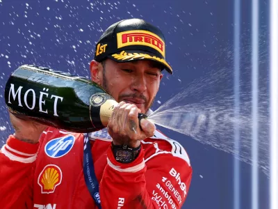 Formula One F1 - Barcelona-Catalunya Grand Prix - Circuit de Barcelona-Catalunya, Barcelona, Spain - June 14, 2026 Ferrari's Lewis Hamilton celebrates on the podium with champagne after winning the Barcelona-Catalunya Grand Prix REUTERS/Bruna Casas   TPX IMAGES OF THE DAY
