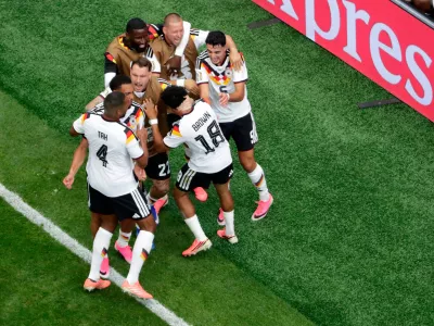 Germany's Nathaniel Brown (18) is congratulated by teammates after scoring during the World Cup Group E soccer match between Germany and Curacao in Houston, Sunday, June 14, 2026. (AP Photo/Michael Wyke)