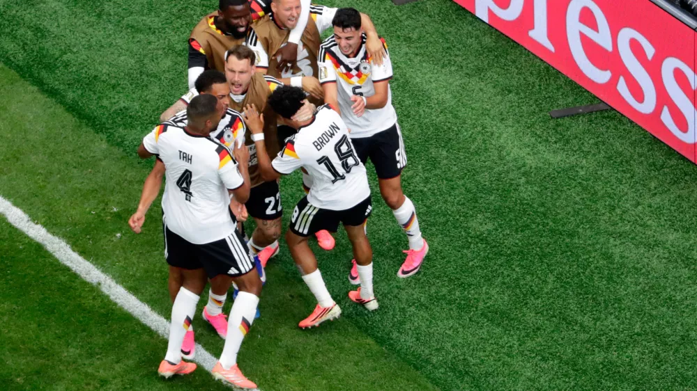 Germany's Nathaniel Brown (18) is congratulated by teammates after scoring during the World Cup Group E soccer match between Germany and Curacao in Houston, Sunday, June 14, 2026. (AP Photo/Michael Wyke)