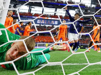 Soccer Football - FIFA World Cup 2026 - Group F - Netherlands v Japan - Dallas Stadium, Arlington, Texas, U.S. - June 14, 2026 Japan's Daichi Kamada celebrates scoring their second goal as Netherlands' Bart Verbruggen reacts REUTERS/Hannah Mckay   TPX IMAGES OF THE DAY