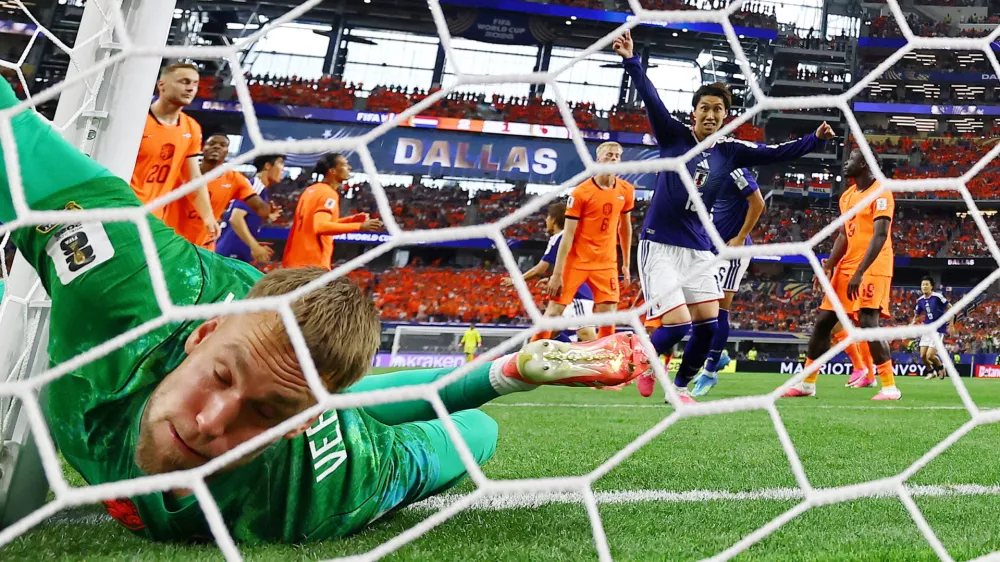 Soccer Football - FIFA World Cup 2026 - Group F - Netherlands v Japan - Dallas Stadium, Arlington, Texas, U.S. - June 14, 2026 Japan's Daichi Kamada celebrates scoring their second goal as Netherlands' Bart Verbruggen reacts REUTERS/Hannah Mckay   TPX IMAGES OF THE DAY