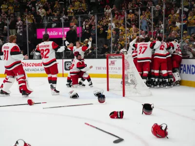 Jun 14, 2026; Las Vegas, Nevada, USA; Carolina Hurricanes players celebrate the win against the Vegas Golden Knights in game six of the 2026 Stanley Cup Final at T-Mobile Arena. Mandatory Credit: Stephen R. Sylvanie-Imagn Images