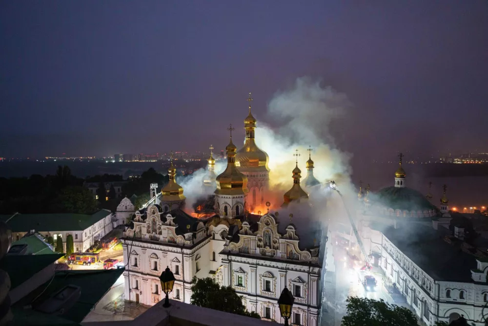 Rescue workers try to put out a fire at the Dormition Cathedral of thousand-year-old Monastery of Caves, also known as Kyiv Pechersk Lavra, following a Russian strike on Kyiv, Ukraine, Monday, June 15, 2026. (AP Photo/Evgeniy Maloletka)