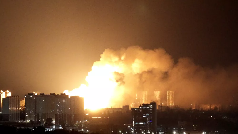 An explosion lights up the sky over the city during a Russian missile and drone strike, amid Russia's attack on Ukraine, in Kyiv, Ukraine June 15, 2026. REUTERS/Anna Voitenko