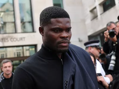 Former Arsenal player Thomas Partey, who has been charged with five counts of rape and one count of sexual assault, walks outside Westminster Magistrates' Court, in London, Britain, August 5, 2025. REUTERS/Hannah McKay
