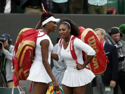 FILE -Serena Williams, right, and her sister Venus of the U.S celebrate after winning their women's doubles match against Andreja Klepac and Katarina Srebotnik of Slovenia on day four of the Wimbledon Tennis Championships in London, June 30, 2016. (AP Photo/Tim Ireland), File)