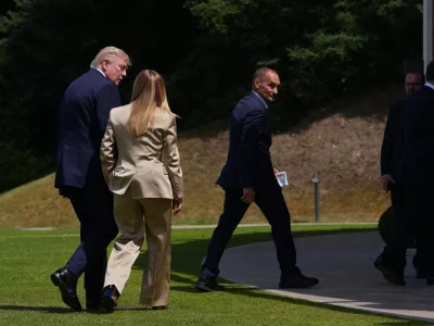 U.S. President Donald Trump, left, speaks with Italian Prime Minister Giorgia Meloni, second left, after a group photo of G7 leaders and invited nations during the G7 summit in Evian-les-Bains, France, Tuesday, June 16, 2026. (AP Photo/Thibault Camus)